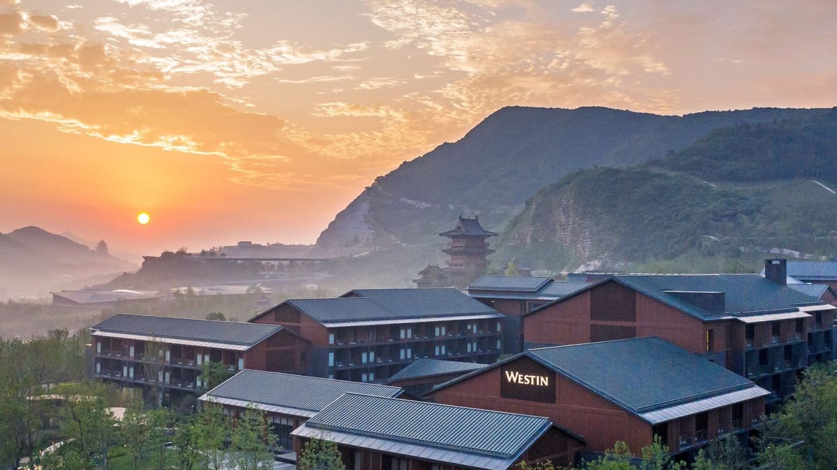 Westin hotel wings at sunrise with a river valley and hills behind